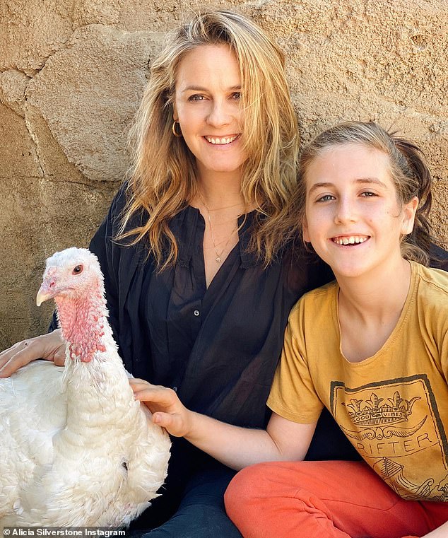 Happy holiday: Alicia Silverstone posed with her son Bear and a turkey on Thanksgiving