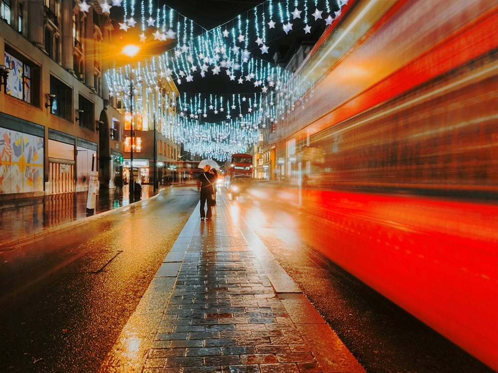 london street at night christmas lights and red bus long exposure iphone 12 pro