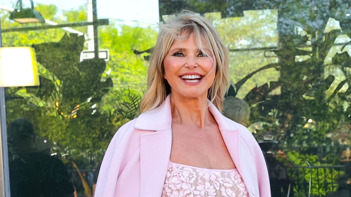 Christie Brinkley shows off sun kissed tan wearing just a shirt in stunning beach photo