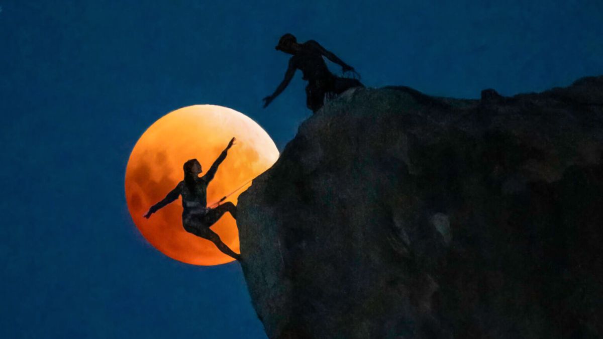 2022 first-place winner in the Connecting to the Dark category was ‘Rock climbers under a rising blood moon’ by Chris Olivas
