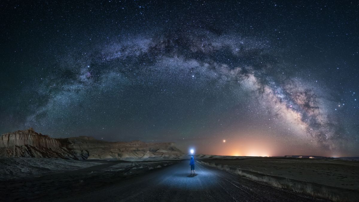 A man watching the Milky Way on a lost road in Utah. Grand Staircase-Escalante National Monument.